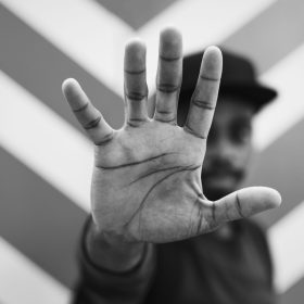 African man doing a "Talk to the hand!" pose